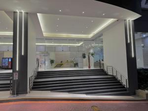 a staircase in a building with a escalator at HaBiBi hOmE Klcc in Kuala Lumpur +92 photos