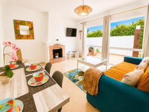 a living room with a blue couch and a table at Cristina Bungalow in Estepona