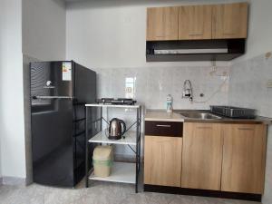 a small kitchen with a refrigerator and a sink at Villa Chaloski in Peštani