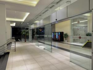 an empty lobby with glass doors in a building at HaBiBi hOmE Klcc in Kuala Lumpur
