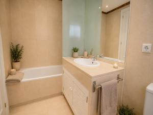 a bathroom with a sink and a bath tub at Cristina Bungalow in Estepona +41 photos
