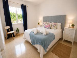a bedroom with a large bed with two pillows at Cristina Bungalow in Estepona