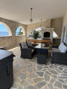 a living room with a couch and a fireplace at Villa Bavaria in Starigrad