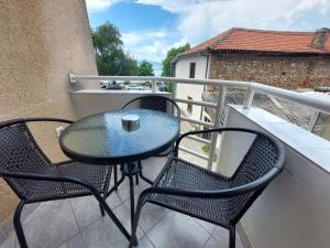 a table and two chairs on a balcony at Villa Chaloski in Peštani