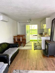 a living room with a couch and a kitchen at Apartment Stanic in Šipovo
