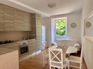 a kitchen and dining room with a table and a dining room at Vicolo Carate in Gravedona