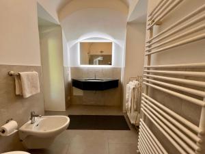 a bathroom with a black sink and a mirror at Vicolo Carate in Gravedona +10 photos