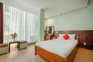 a bedroom with a large bed and a large window at Art Deluxe Hotel in Nha Trang +54 photos