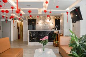 a lobby with a vase of flowers on a table at Art Deluxe Hotel in Nha Trang