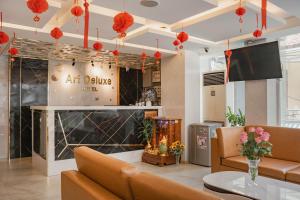 an art salon with a couch and a table at Art Deluxe Hotel in Nha Trang