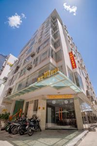a building with motorcycles parked in front of it at Art Deluxe Hotel in Nha Trang