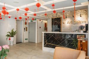 a lobby with red lanterns in a building at Art Deluxe Hotel in Nha Trang