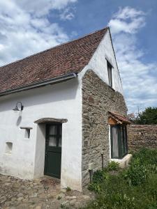 an old stone house with a green door at Archita 155 in Archita