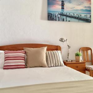 a bedroom with a bed with a picture on the wall at Apartamento JB - Dona Ana in Lagos