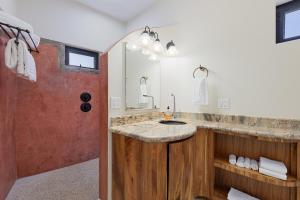 a bathroom with a sink and a large mirror at Casa Girasol Ocean Views Steps to Beach in Buenavista +41 photos
