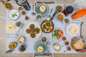 a table with plates of food on it at Beit Al Baraka in Um Qeis