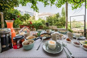 a table with dishes of food and drinks on it at Beit Al Baraka in Um Qeis