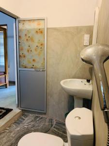 a bathroom with a toilet and a sink at Vinka Place Arugambay in Arugam Bay +119 photos