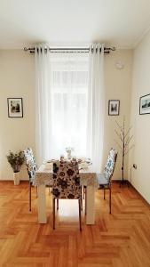 a dining room with a table and chairs and a window at Lavender - City Room with free parking in Pula +28 photos
