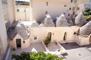 an aerial view of a building with pointed roofs at Trullo Màufra in Locorotondo