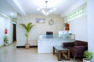 a living room with a bar and a couch at Hotel SP Grand Near Mohali Bus Stand & Civil Hospital in Mohali