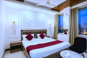 a bedroom with a bed and a chair and a window at Hotel SP Grand Near Mohali Bus Stand & Civil Hospital in Mohali +18 photos