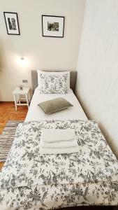 a bedroom with a bed with a black and white blanket at Lavender - City Room with free parking in Pula