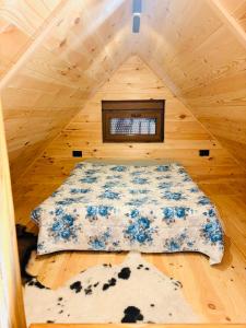 a bed in a tiny house with a window at Falcon Cottage,Montenegro in Korita