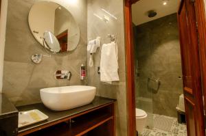 a bathroom with a sink and a mirror at Jullundur Hotel & Restaurant in Chandīgarh +25 photos