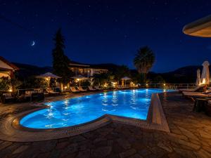 a large swimming pool at night at Annamaria Studios & Apartments in Petra