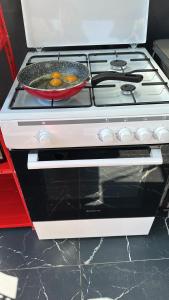 a stove with a frying pan on top of it at Villa Violand 2 in Limanu +16 photos