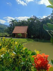 a small pond with a building in the background at Cabana mandaçaia in Timbe do Sul +8 photos