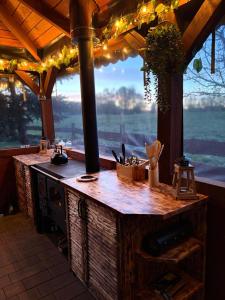 an outdoor kitchen with a counter with a large window at Domek na Mazurach - nad jeziorem Dadaj in Wilimy +12 photos