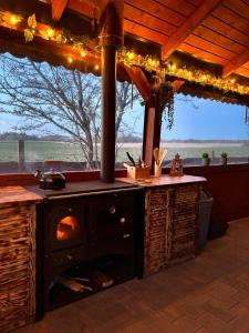 an outdoor kitchen with an outdoor oven with lights at Domek na Mazurach - nad jeziorem Dadaj in Wilimy