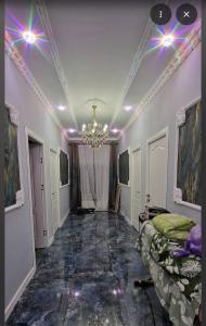 a room with a chandelier on the ceiling and a hallway at Tyom in Khodzhabegi