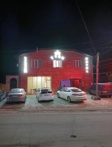 three cars parked in front of a red brick building at Tyom in Khodzhabegi