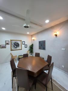 a dining room with a wooden table and chairs at The Crib, Murree Hills in Lower Topa