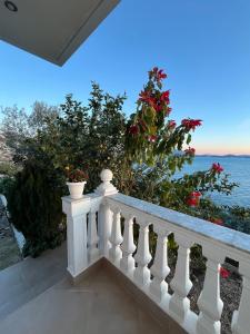 a white balcony with a view of the ocean at Home Majka in Sarandë