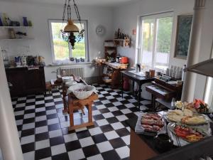 a kitchen with a black and white checkered floor at Ankis Bed and Brekfast, Vimmerby in Vimmerby