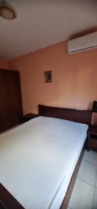 a bedroom with a white bed in a room at Emma 2 in Budva