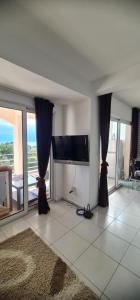 a living room with a flat screen tv on the wall at Emma 2 in Budva