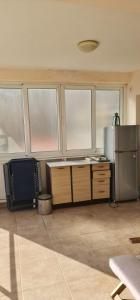 a kitchen with a refrigerator and a desk with a microwave at Emma 2 in Budva