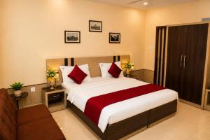 a hotel room with a bed and a couch at Central Hotel in Lucknow