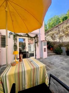 a table with an umbrella on a patio at Authentic Tuscan Studio in Lucca with Private Patio in Lucca
