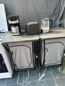a table with two appliances on top of it at Villa Violand 3 in Limanu