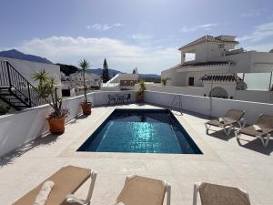 a swimming pool on the roof of a house at Salida Del Sol in Nerja