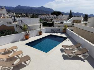 a swimming pool on the roof of a house at Salida Del Sol in Nerja