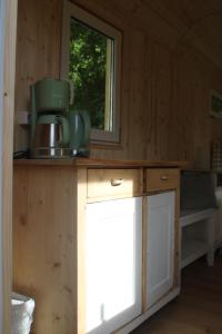 a kitchen with a counter top with a window at FreiLAND-Häusle in Weikersheim +4 photos
