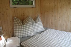two pillows sitting on a bed in a room at FreiLAND-Häusle in Weikersheim