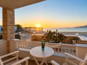 a table and chairs on a balcony with a view of the ocean at Ammos Boutique Rooms-Seafront Stay in Elafonisos in Elafonisos